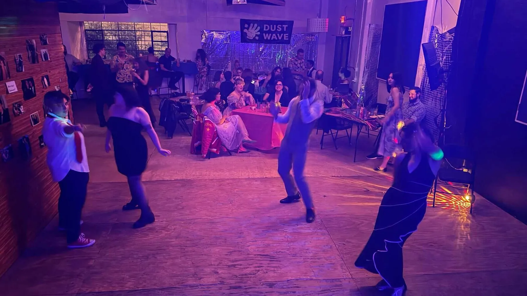 Guests dance beneath purple lights at Dancewave in Juno Brewery